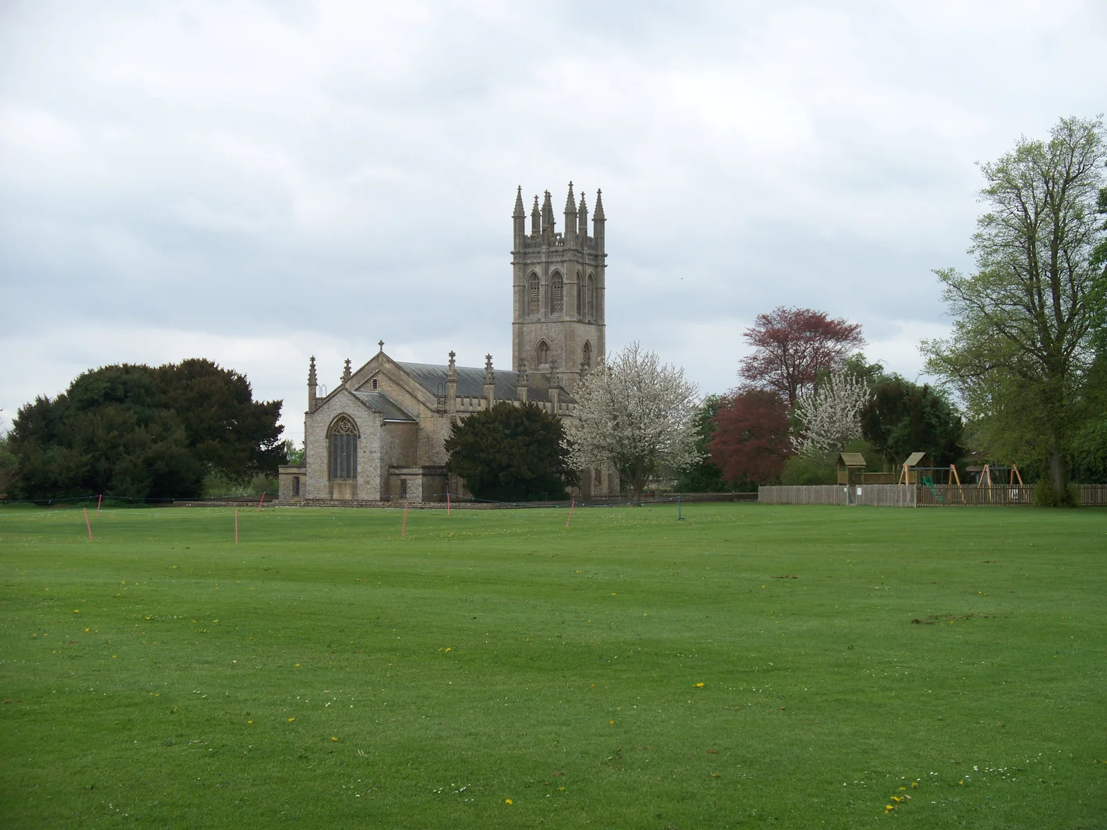 All Saints Church and village green in Churchill, Oxfordshire